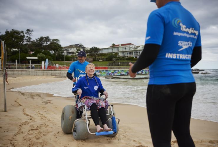 新南威尔士州，悉尼，邦迪海滩，海滩冲浪之旅，一位坐在海滩轮椅上的女子 © 澳大利亚旅游局版权所有