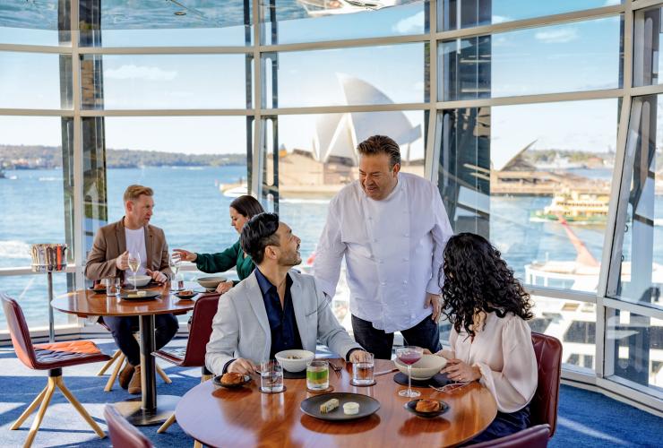 新南威尔士州,悉尼,Quay 餐厅,主厨与在餐厅用餐的食客交谈,远处是悉尼歌剧院 © 澳大利亚旅游局版权所有